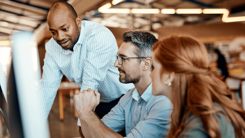 Three gents discussing an issue in a stylish office with lofted ceilings