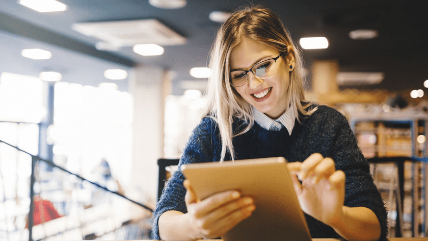 Smiling woman using a tablet computer