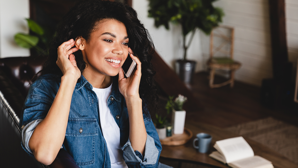 Woman talking on her cell phone at home