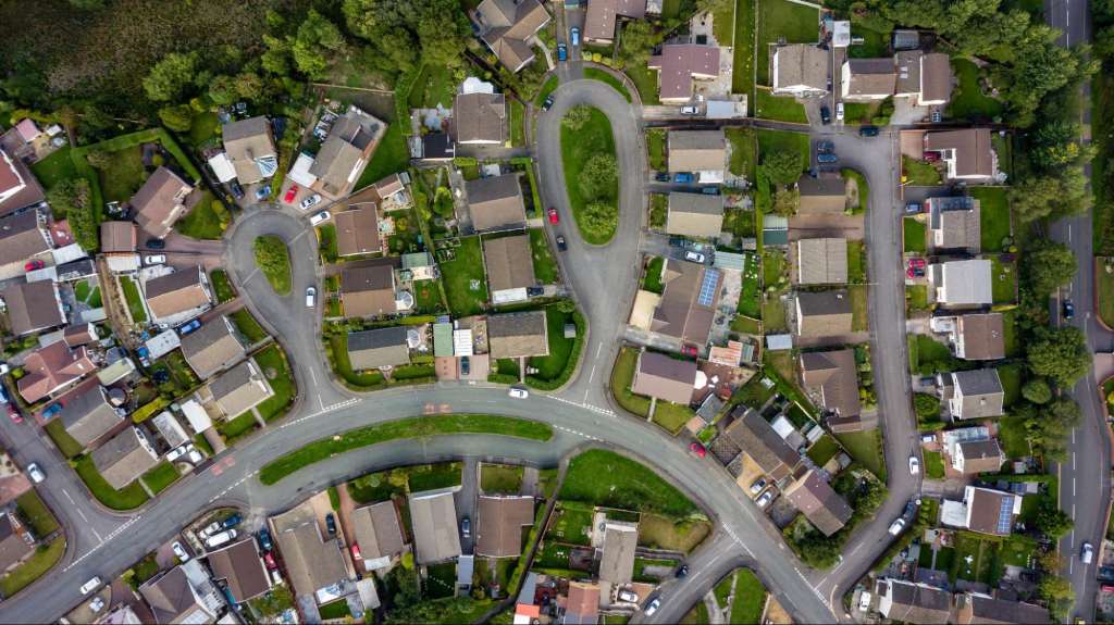 Top down aerial view of urban houses and streets in a residential area of a Welsh town.