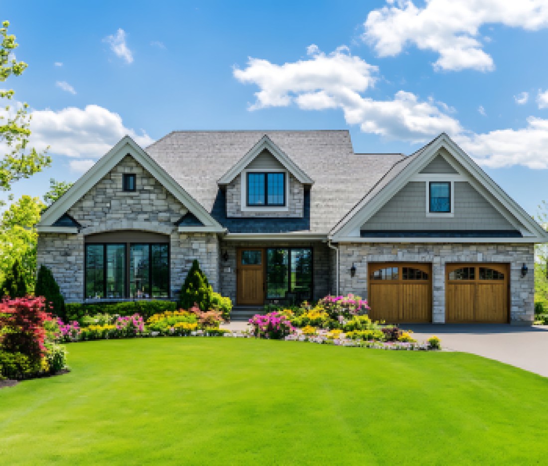 Highly detailed, bright, and clear photograph of a beautiful suburban home with a large front yard and a perfectly manicured lawn in the springtime.