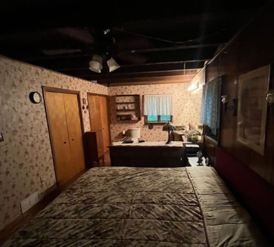 Dark bedroom with a small light at the back of the room